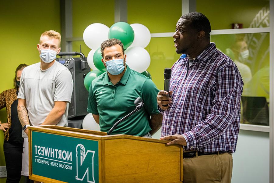 Dr. Justin Mallett, the University’s assistant vice president for diversity and inclusion, is flanked by Northwest student-athletes Elijah Green and Braden Wright as he addresses a crowd gathered Thursday to celebrate the opening of the remodeled Office of Diversity and Inclusion. 